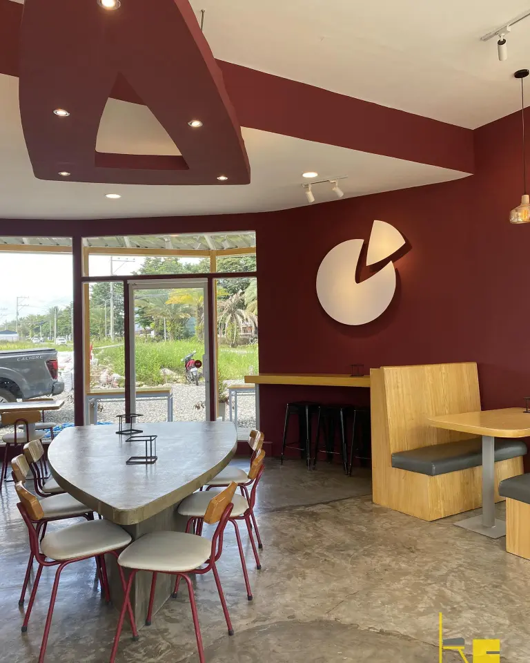 Interior of Demetrios Pizzeria at Flagship, showing a unique heart-shaped table and modern decor.