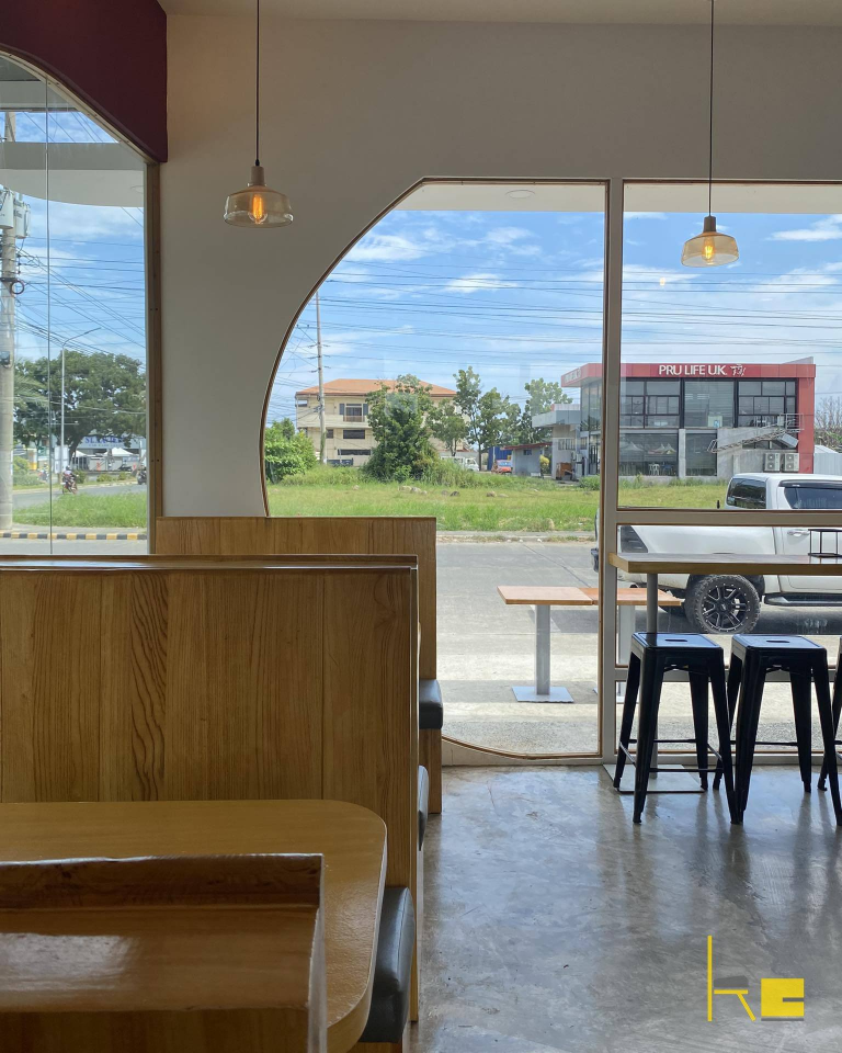 Demetrios Pizzeria offers a bright and inviting dining area with large windows providing a view of the street.