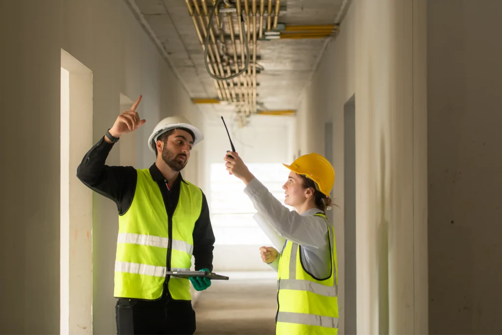 Construction professionals meticulously inspect a building's interior, ensuring adherence to design specifications and quality standards.