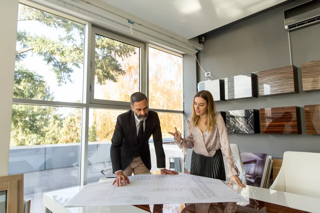 Interior designer and client reviewing design plans together.